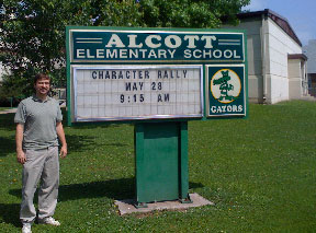 Michael Longfellow and school sign